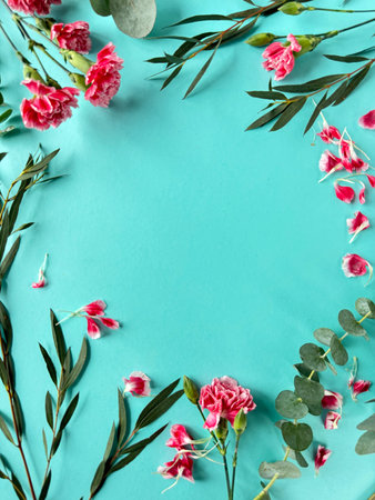 Blue Background With Pink Carnation Flowers and Green Leaves, Copy-space on Greeting Card.の写真素材