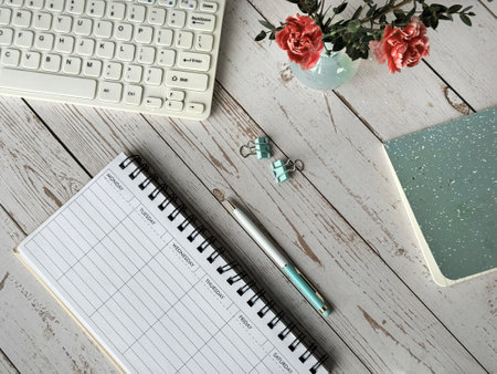 Desk With Blank Weekly Planner, Keyboard and Notepadの写真素材