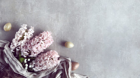 Pink hyacinth flowers, linen towel and Easter eggs. Springtime Easter overhead banner with...