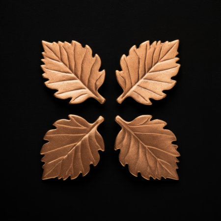 Symmetrical Arrangement of Four Ceramic Oak Leaves on Black Backgroundの素材