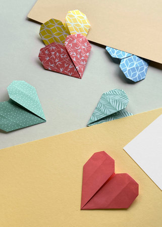 Colorful Origami Paper Hearts on Pastel Background for Crafting and DIY Projectsの写真素材