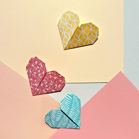Colorful Origami Paper Hearts on Pastel Geometric Backgrounds for Valentines Dayの写真素材