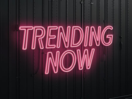 Trending Now Neon Sign on Black Metallic Background for Modern Advertisements and Social Media Promotionsの素材