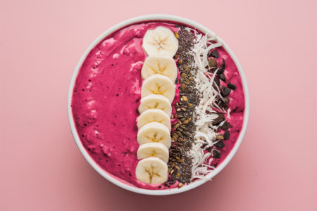 Vibrant Smoothie Bowl with Banana Slices and Chia Seeds on Pink Backgroundの素材