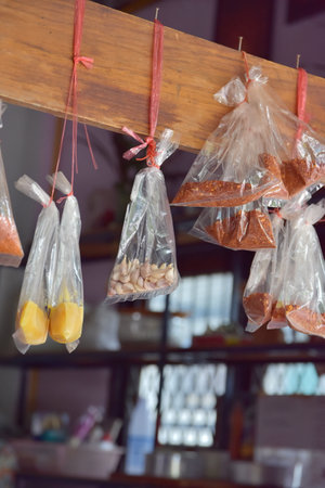 Dried fruits in plastic bags hanging on the wallの写真素材