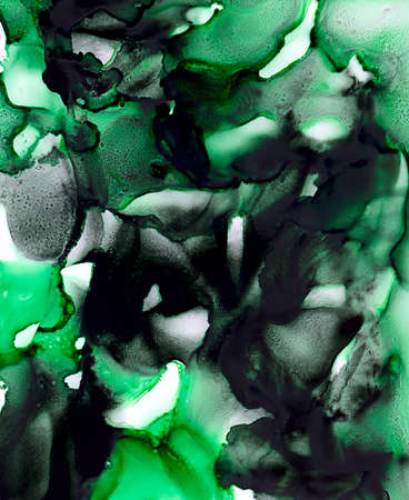 Abstract paint black green merging uneven.Colorful background hand drawn with bright inks and watercolor paints. Color splashes and splatters create uneven artistic modern design.の写真素材
