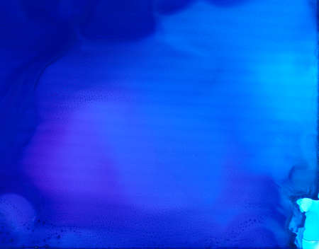 Deep blue smooth flow.Colorful background hand drawn with bright inks and watercolor paints. Color splashes and splatters create uneven artistic modern design.の写真素材