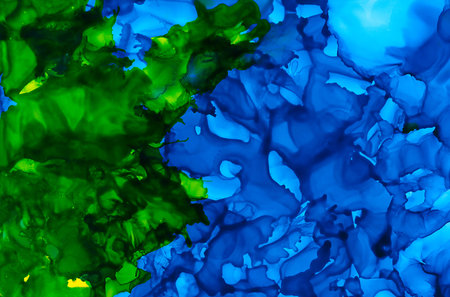 Blue and green paint uneven texture.Colorful background hand drawn with bright inks and watercolor paints. Color splashes and splatters create uneven artistic modern design.の写真素材