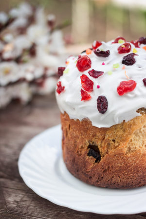 Easter sweet bread Orthodox kulich, paska, willow twigs. Easter Colorful eggs on gray wooden...