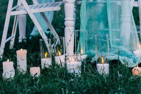 Romantic candle decoration on the summer grass.の写真素材