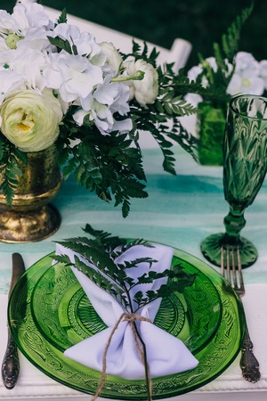 Decorated wedding table with candles in the garden.の写真素材