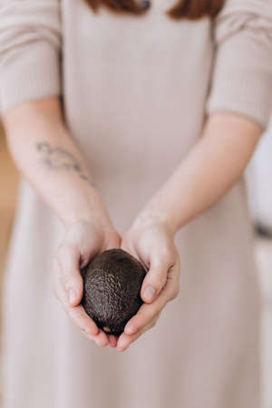 Hands holding fresh avocado. Closeupの写真素材