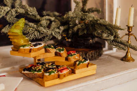 Italian bruschetta with cream cheese, strawberry, arugula and balsamic vinegar sauce with honey. Appetizer with chiabatta bread and strawberry on wooden background. Italian breakfast. Italian cuisine.の写真素材