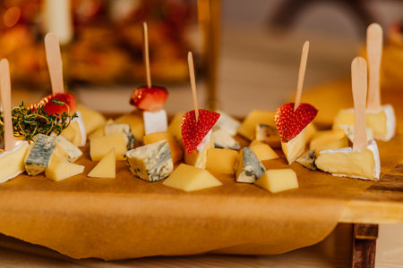 Cheese plate with grapes and nuts on wooden table, top view. Catering Service Photography.の写真素材