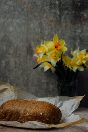 delicious and healthy homemade whole grain bread with honey. place for text. yellow flowers in the...