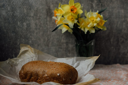 delicious and healthy homemade whole grain bread with honey. place for text. yellow flowers in the...