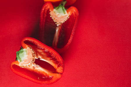 SWEET, fresh RED PEPPER ON A RED BACKGROUND, cut in half, thick smoke around. proper nutrition. fresh vegetablesの写真素材