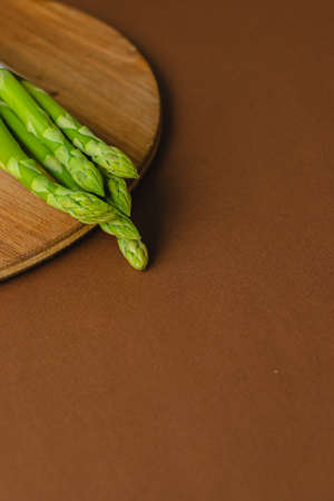 branches of fresh green asparagus on a wooden background, top viewの写真素材