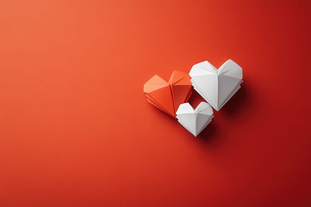Origami hearts on red background - minimalist love concept.の写真素材