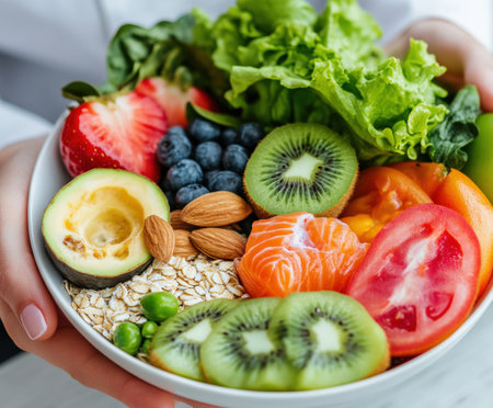 Colorful fresh fruit and vegetable bowl with kiwi and berries.の写真素材