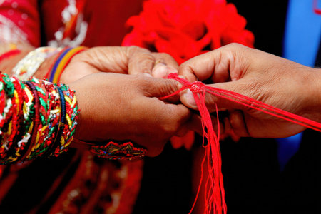 Traditional ceremony with red thread symbolizing cultural unity and togetherness.