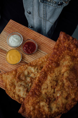 Crispy pastel with sauces on wooden board.の写真素材