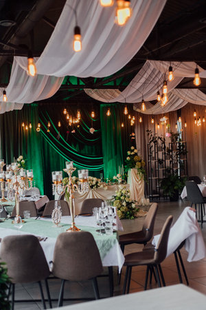 Elegant wedding reception with draped ceiling and soft lighting in upscale venue.の写真素材