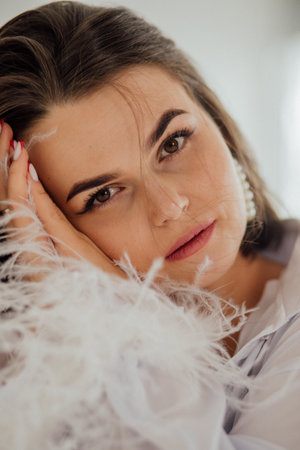 Female caucasian adult with feathered accessory close-up.の写真素材