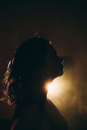 Silhouette of a person in dramatic lighting with a mysterious ambiance.の写真素材