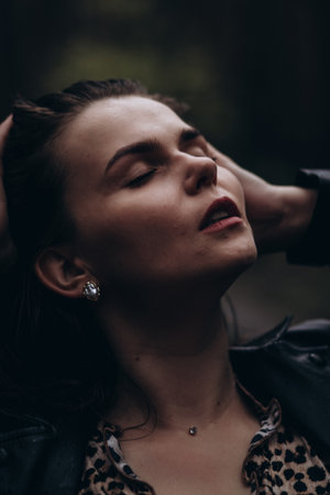 Serene woman in nature enjoying a moment of tranquility.の写真素材