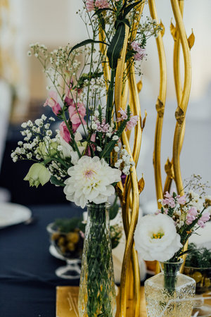 Elegant floral arrangement with gold accents for a luxurious celebration setting.の写真素材