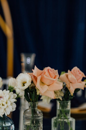 Elegant floral arrangement with pink and white roses in glass vases.の写真素材