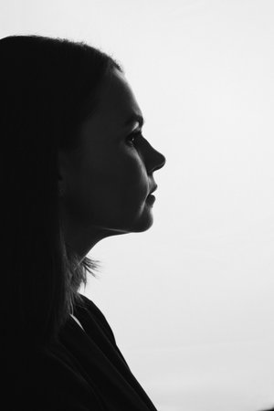 Black and white side profile portrait of a woman in silhouette.の写真素材