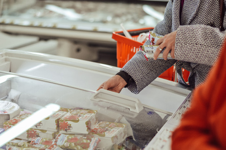women's hands opening the refrigeratorの写真素材