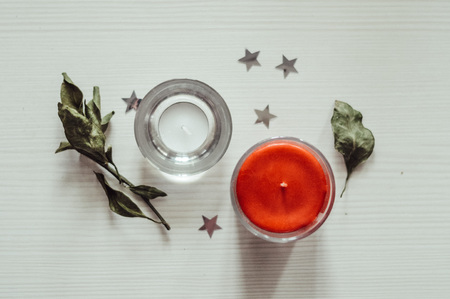 two candles standing on a white wooden backgroundの写真素材