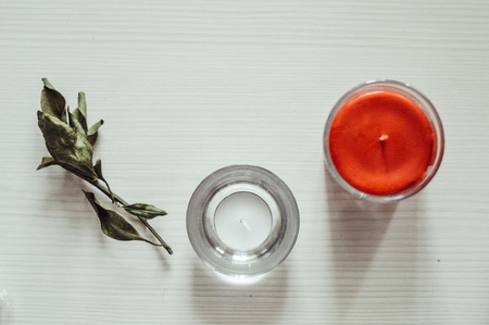 two candles standing on a white wooden backgroundの写真素材