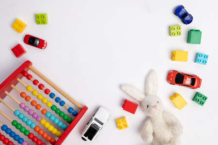 toys constuctor and cars, top view on white background, place for textの写真素材