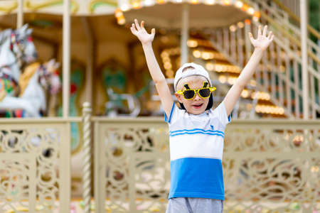 a cheerful child a boy of 5-6 years old walks in an amusement Park. Children lifestyleの写真素材