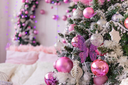 new year's interior of the house in pink, Christmas tree with balloons and a bedの写真素材