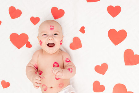 baby among hearts and with kisses from red lipstick, the concept of love and Valentine's day