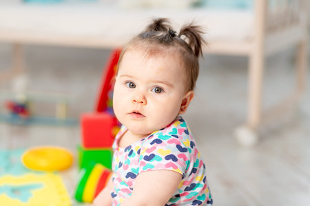 portrait of a baby with a toy at home or in kindergarten. Toys for small children. early development