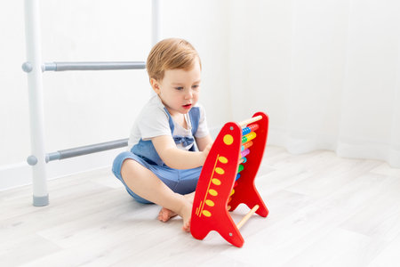 a child with bills at home, a cute boy playing or counting on bills