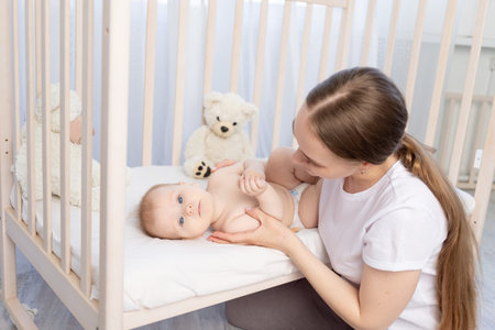 mom puts baby to sleep in the crib or gives him a rodent, happy family.