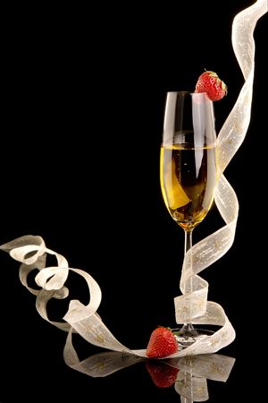 New Year champagne with christmas ribbons and strawberriesの写真素材
