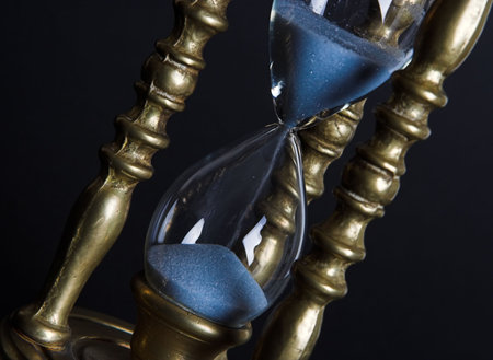 Bronze hourglass against a black background