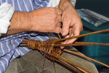 Hands of a craftsman, making baskets