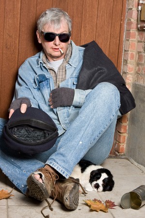 Blind beggar and his dog on the streetsの写真素材