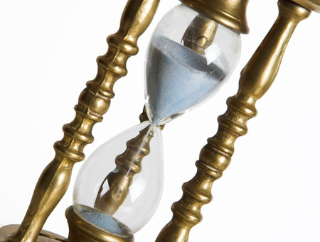 Bronze hourglass against a white background