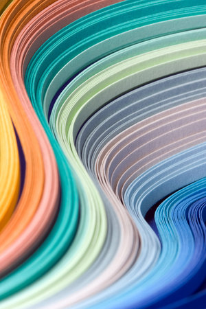 Abstract design of filigree paper strips folded in waves