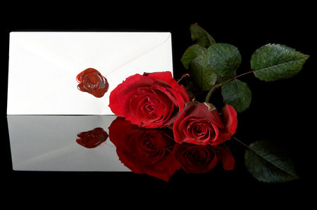Sealed love letter and two red rosesの写真素材